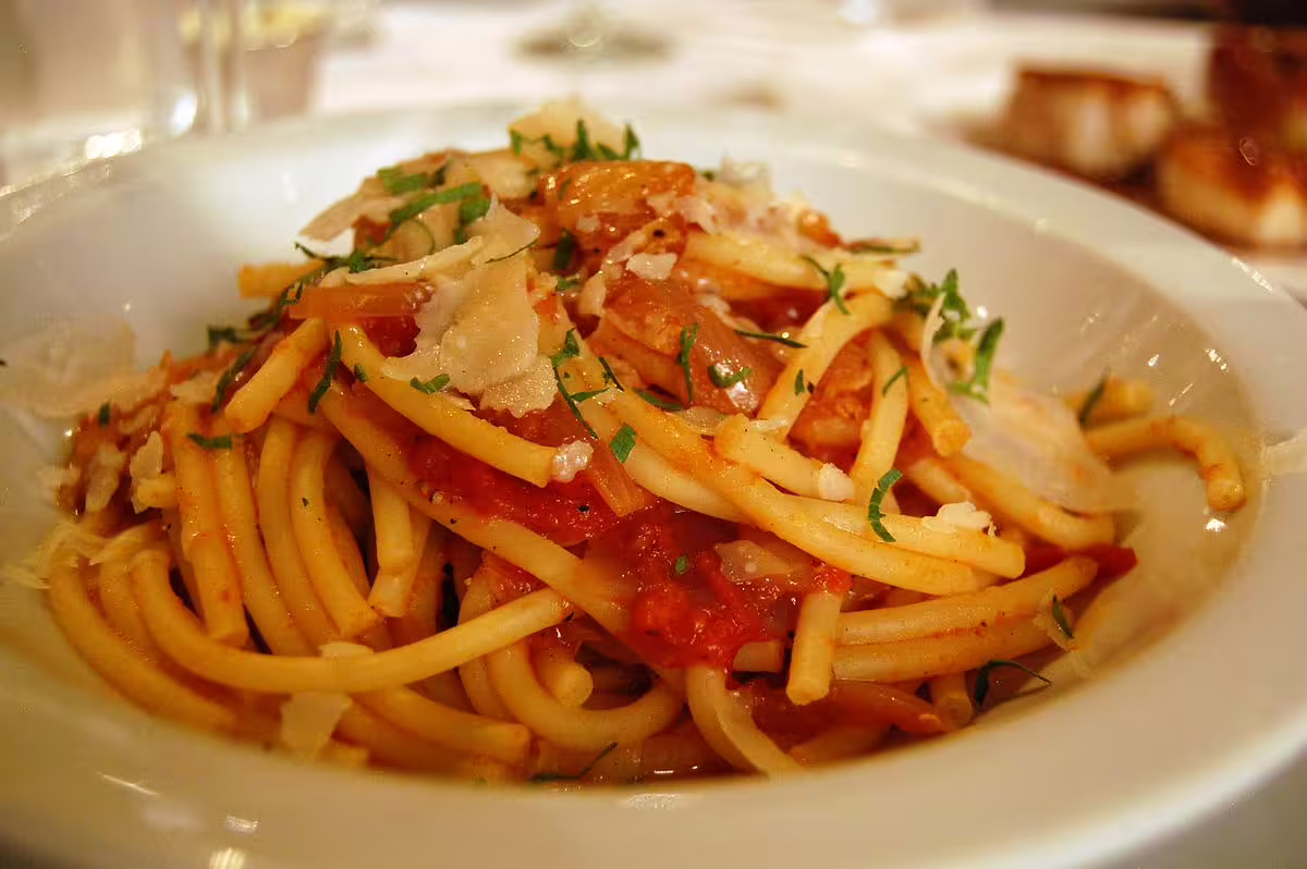 Traditional Roman pasta all’amatriciana served in a trattoria, highlighting authentic cuisine on a 4-day Rome city break.