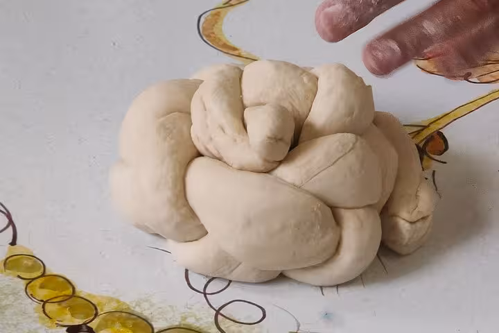 Close-up of expertly kneaded dough ready for pasta making in a private Rome cooking class experience.