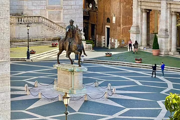 Tourists explore Piazza del Campidoglio and Marcus Aurelius equestrian statue on a private Rome walking tour of squares
