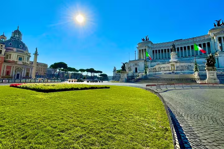 Sunlit Piazza Venezia with Vittoriano monument and manicured lawn on a Rome private sightseeing and catacombs tour
