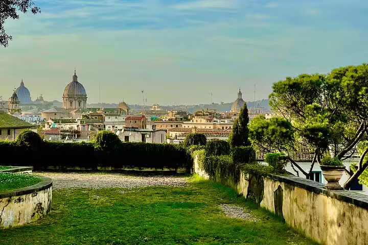 Panoramic view of Rome domes and skyline from a peaceful garden terrace on a Colosseum and Vatican day tour