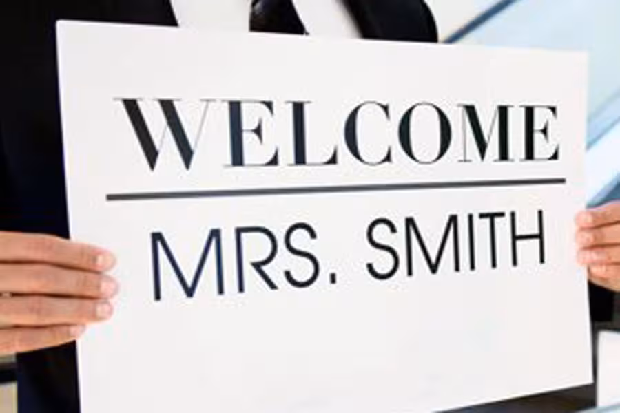 Chauffeur holding a welcome sign for personalized transfer service from Rome Termini to city center.