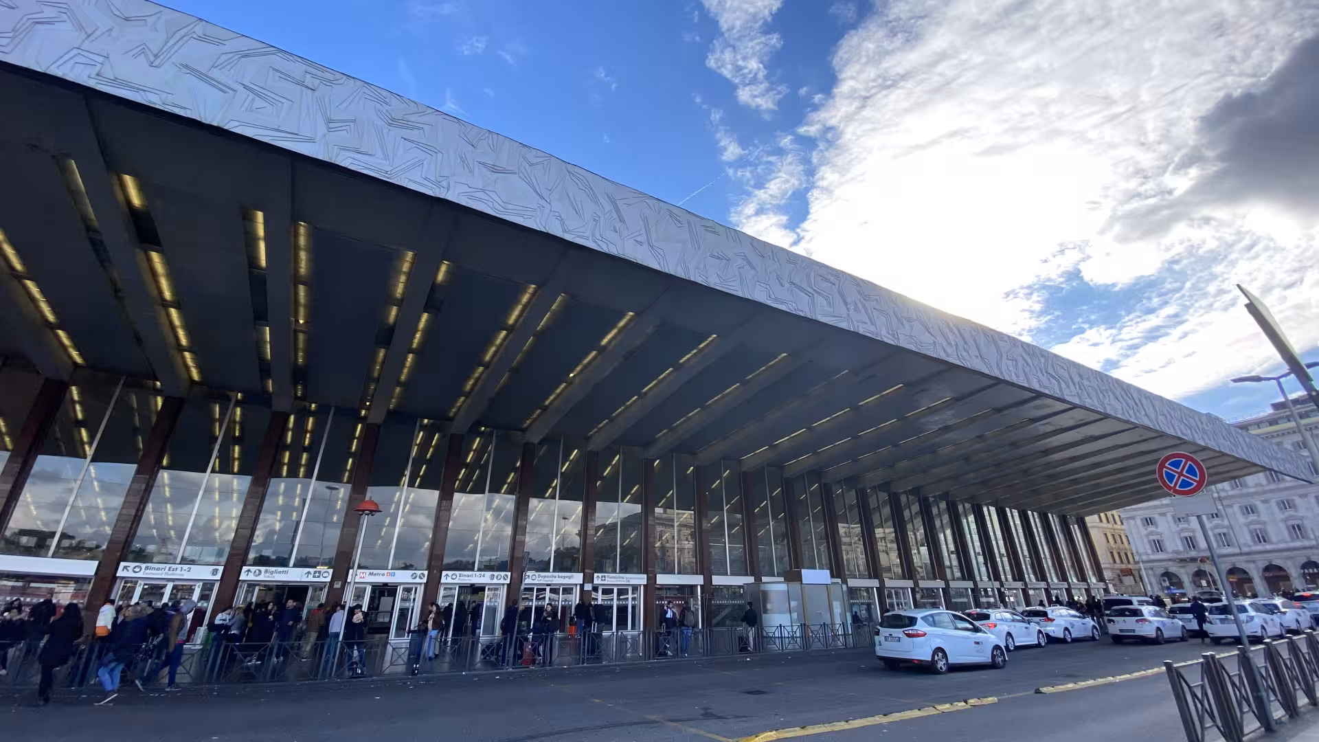 Exterior view of Rome Termini station with taxis lined up, highlighting convenient private transfer options.