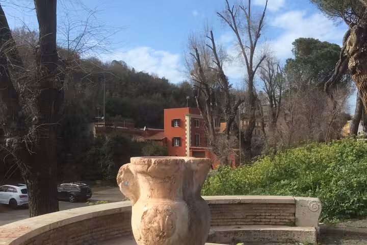 Scenic view of Rome's Testaccio neighborhood featuring rustic architecture and lush greenery.