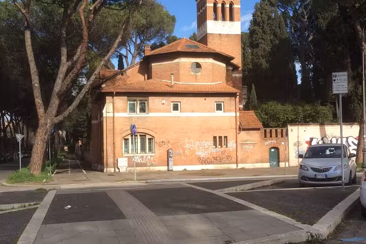 Red brick building with tower in Rome's Testaccio area, a cultural stop on the private food tour itinerary.