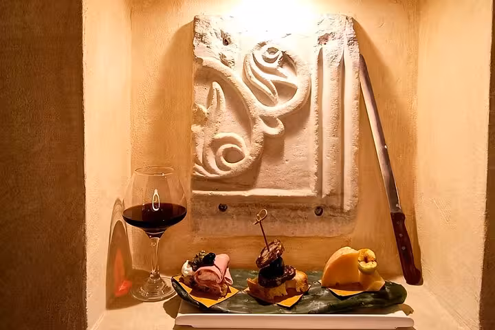 Gourmet Italian appetizers and a glass of red wine displayed in a cozy Trastevere wine bar during a Rome food tasting tour