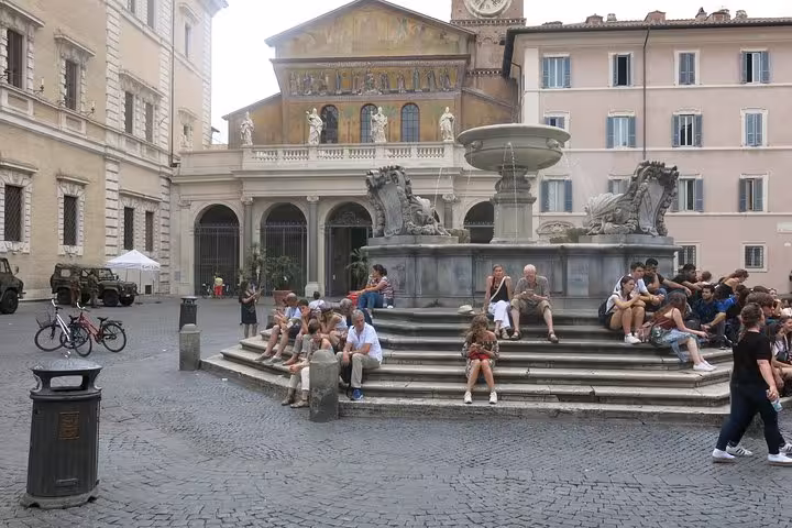 Relax by the historic fountain in Piazza di Santa Maria during the Rome Trastevere Walking Food Tour.