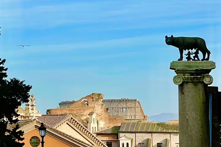 She-wolf statue overlooking ancient Roman Forum ruins, a highlight of the Exclusive Rome and Vatican City shore excursion