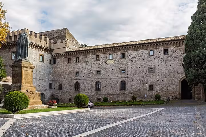 Explore historic stone architecture near Rome on a Vespa tour, featuring ancient buildings and cobblestone pathways.