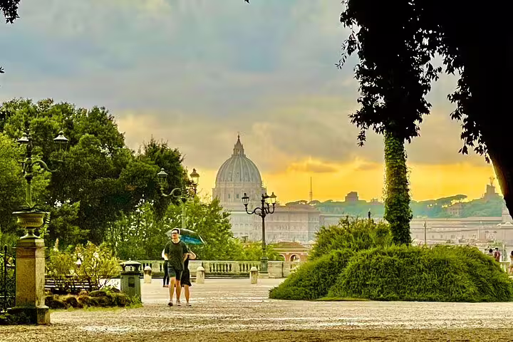 Couple walking in Rome’s Villa Borghese gardens at sunset with panoramic view of St Peter’s dome on a luxury car tour