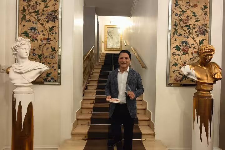 Elegant setting in Rome featuring a man with wine glass, perfect for a mini sommelier wine and food course.