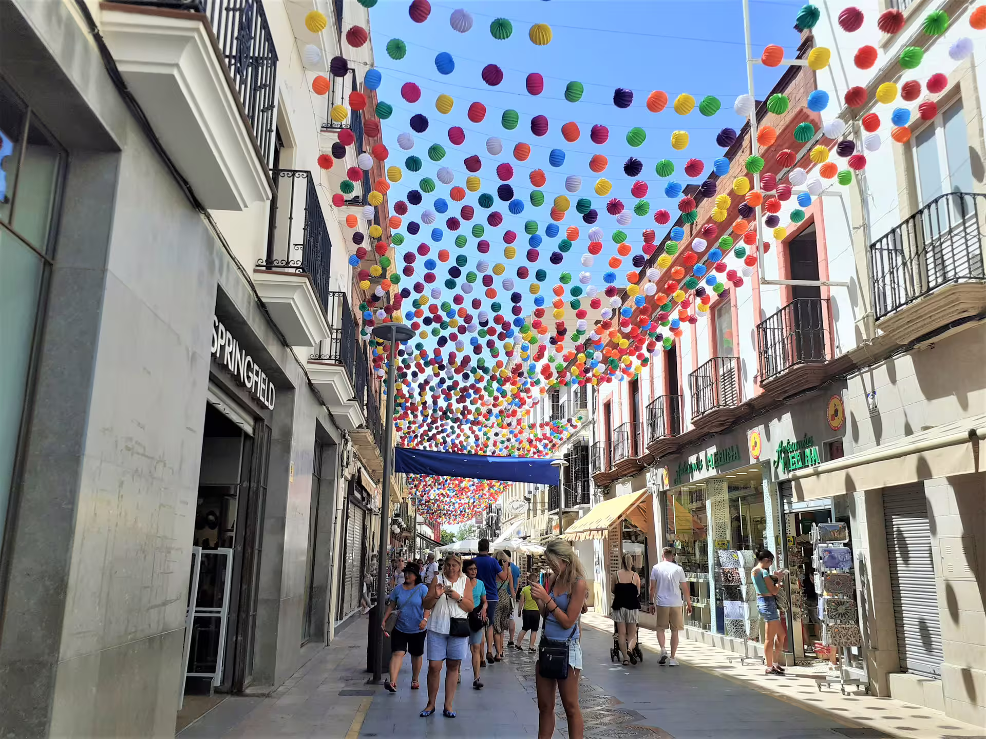 Colorful lantern street in Ronda old town, walking tour scene on Ronda and Setenil day trip with Malaga pick-up