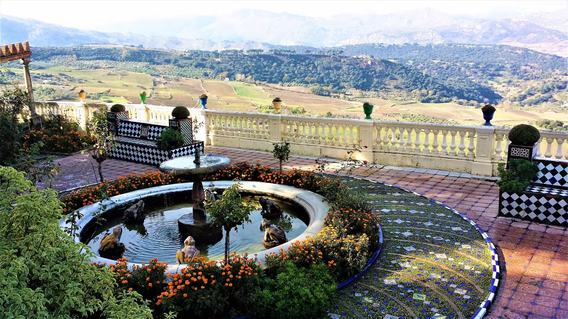 Scenic Ronda viewpoint garden with fountain and mosaic tiles, a highlight on private Costa del Sol day trip