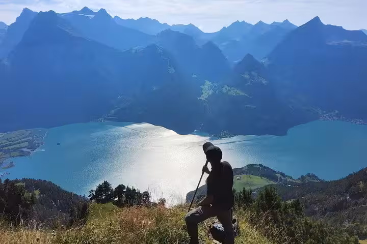 Hiker at Rophaien peak overlooking Lake Lucerne, scenic Swiss Alps viewpoint on Zurich day trip tour