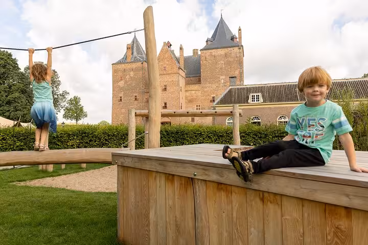 Family-friendly castle courtyard with kids at play on private tour from Rotterdam to historic towns and castles