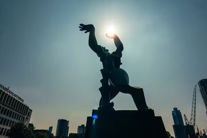 Silhouette of Rotterdam’s The Destroyed City statue, a key stop on a Dutch local highlights walking tour