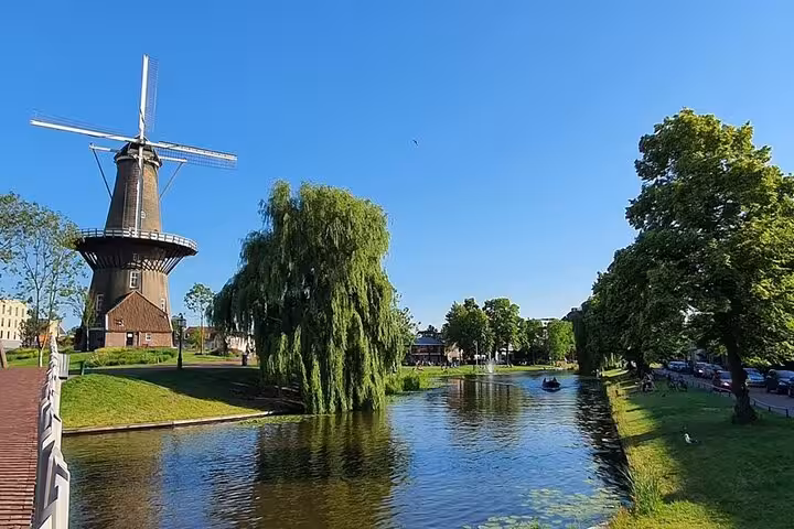 Dutch windmill beside a canal on a private tour from Rotterdam to historic towns, mills and castles