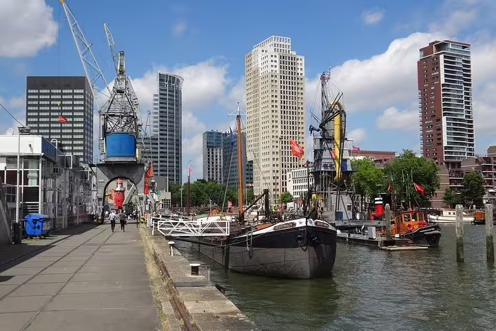 Rotterdam harbor skyline with historic ship and cranes, ideal stop on a self-guided e-scavenger hunt tour