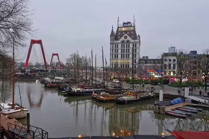 Rotterdam Oude Haven harbor with boats, Witte Huis and Erasmus Bridge on highlights and hidden gems walking tour
