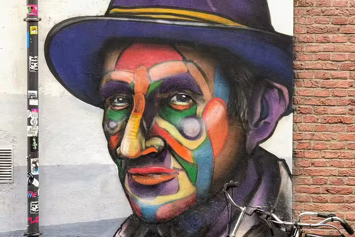 Colorful portrait mural on Rotterdam wall, highlight stop on a private street art walking tour