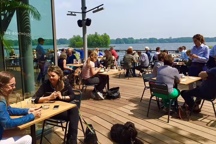 Sunny waterfront terrace in Rotterdam by the lake, a relaxing waypoint on a self-guided e-scavenger hunt