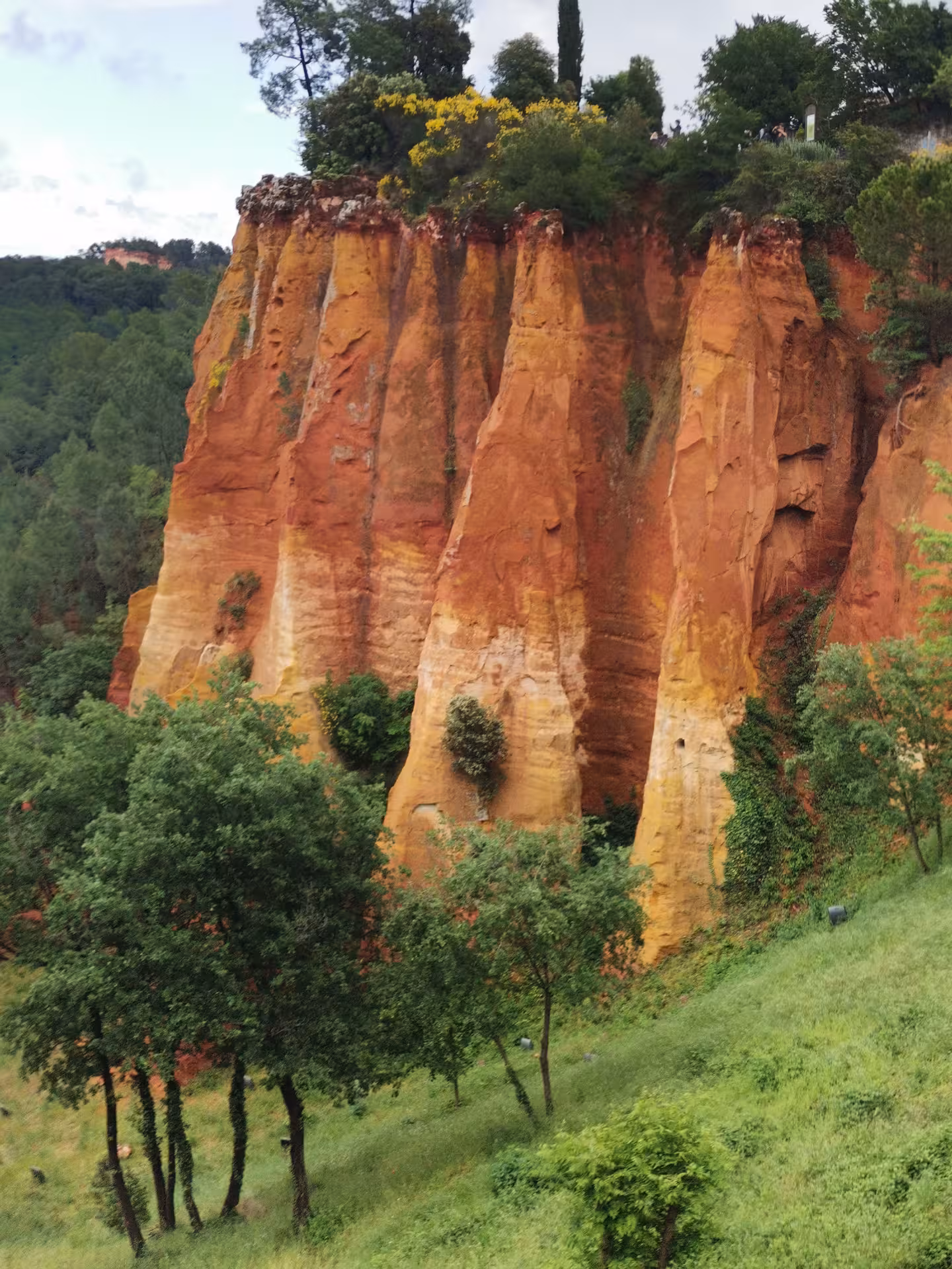 Rust-red ochre cliffs of Roussillon in Provence, dramatic landscape highlight on a Provençal Picnic Tour
