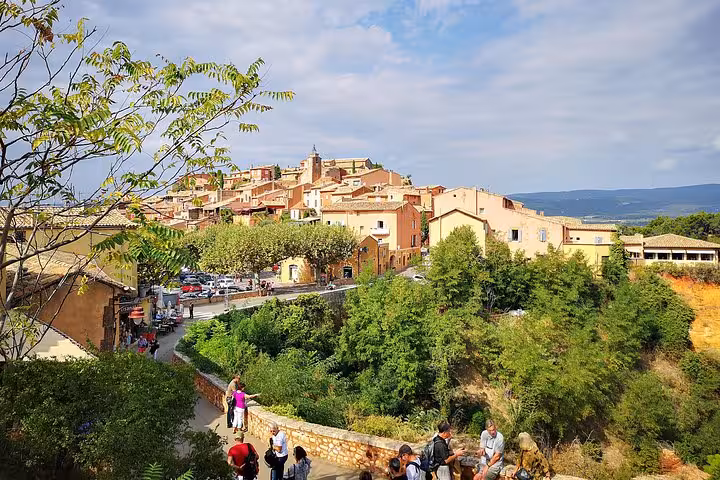Roussillon village viewpoint with ochre houses and visitors on a private Luberon villages day trip from Arles