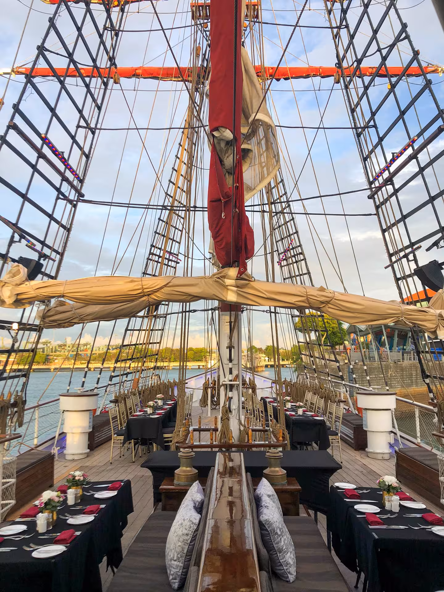 Elegant dining setup on the Royal Albatross deck, ready for a sunset cruise with a sumptuous 7-course dinner.