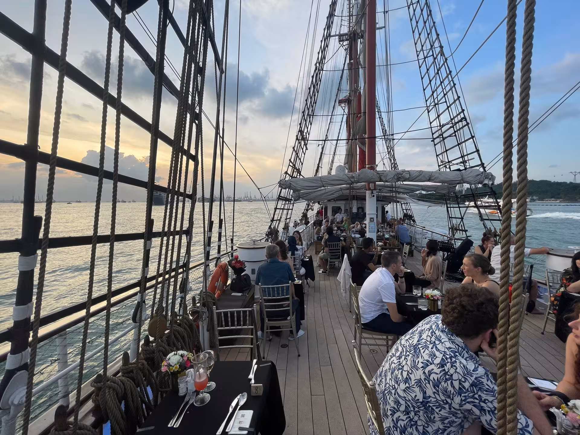Guests enjoying a sunset dinner cruise on the Royal Albatross with a four-course meal and ocean views.