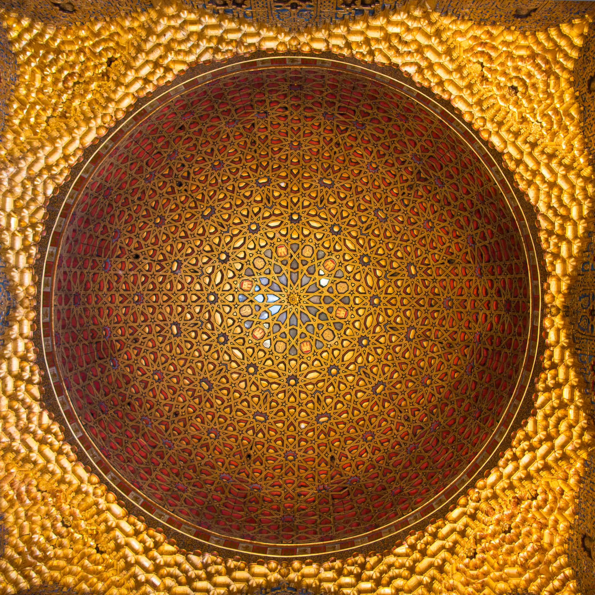 Intricate golden dome ceiling of the Royal Alcazar of Seville showcasing Moorish architecture on a private tour.