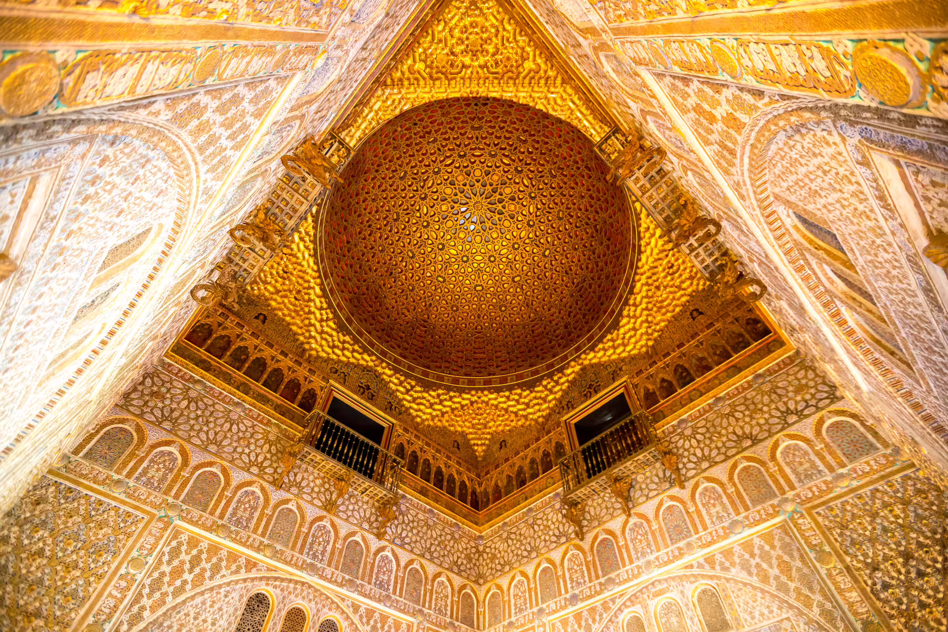 Intricate golden dome ceiling of the Royal Alcazar of Seville, showcasing exquisite Moorish architecture on a private tour.