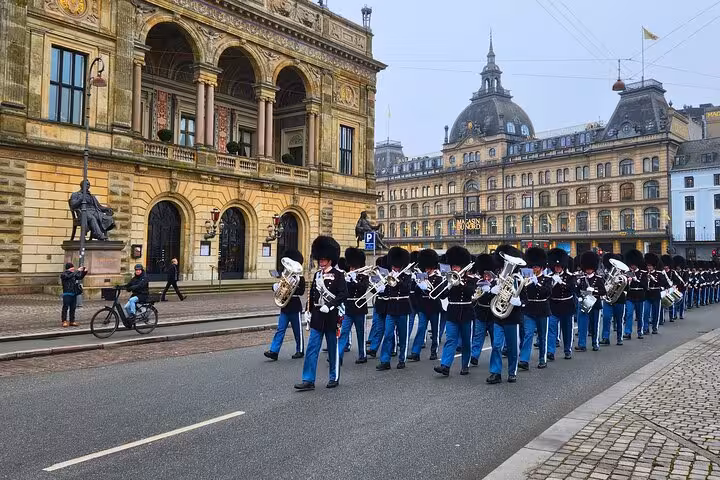 Witness the vibrant Royal Guard parade in front of Copenhagen's historic architecture on our exclusive walking tour.