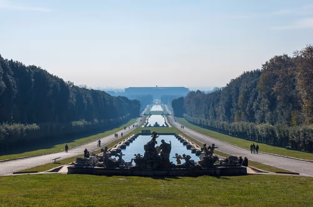 View of the grand gardens and fountains at the Royal Palace of Caserta, a must-see on a Naples day trip.