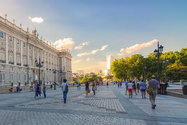 Visitors stroll near the Royal Palace in Madrid, a must-see on the Porto, Coimbra, Fatima, Lisbon & Madrid tour.