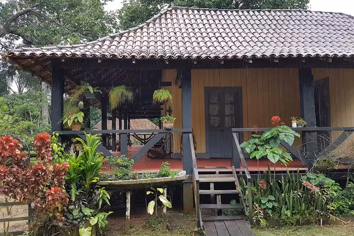 Traditional rubber tapper house at Rubber Museum near Manaus, Amazon history tour with garden