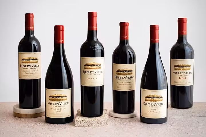 Collection of Rust en Vrede wine bottles showcasing Stellenbosch's finest selections for wine tasting tours.