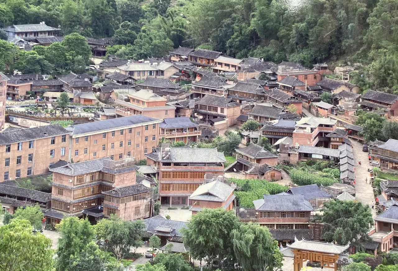 Charming rustic village nestled in verdant hills, showcased in Beijing to Laos Exploration Tour.
