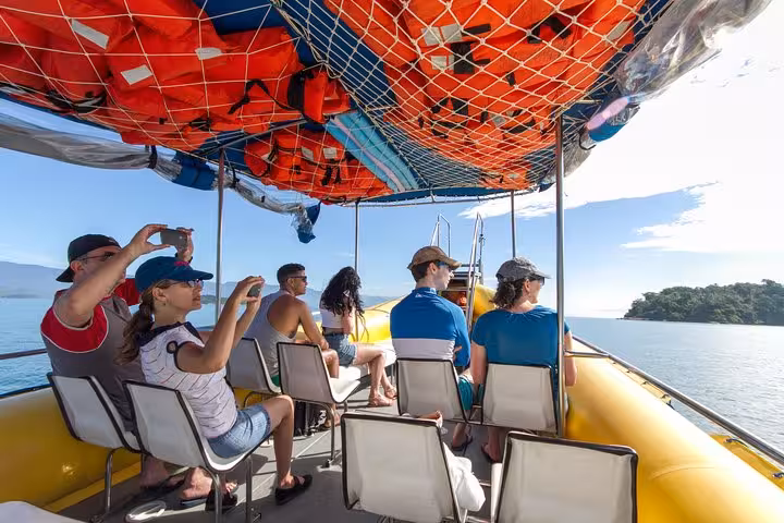 Visitors capture stunning views on a guided boat tour of Saco Mamanguá Fjord’s idyllic beaches.
