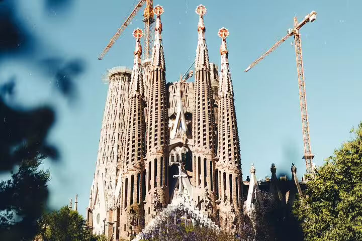 The intricate towers of Sagrada Familia rise against a clear sky, highlighting Barcelona's most famous architectural wonder.