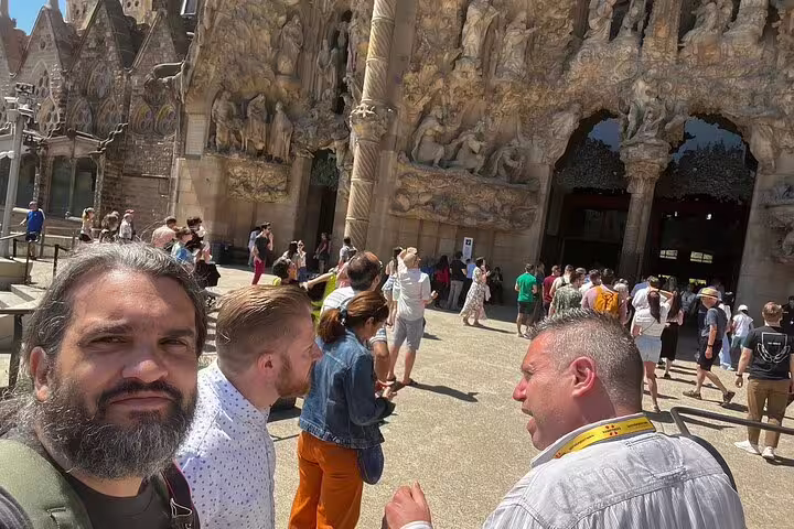 Visitors exploring the intricate facade of the Sagrada Familia, capturing the essence of Barcelona's iconic architecture.