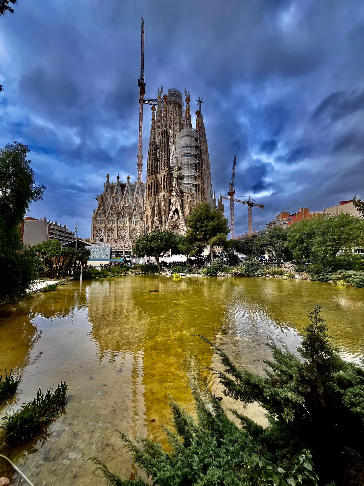 Sagrada Familia Barcelona reflected in pond, iconic Gaudí basilica on Monumentos Locales tour