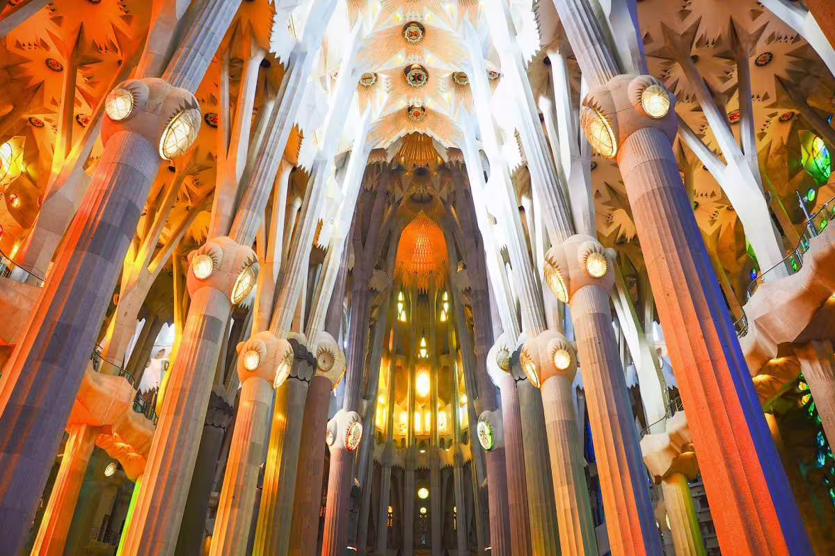 Stunning interior view of Sagrada Familia's illuminated columns during a skip-the-line guided tour in Barcelona.