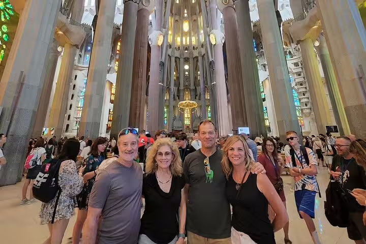 Visitors enjoying the stunning interior of the Sagrada Familia during a semi-private Barcelona tour.