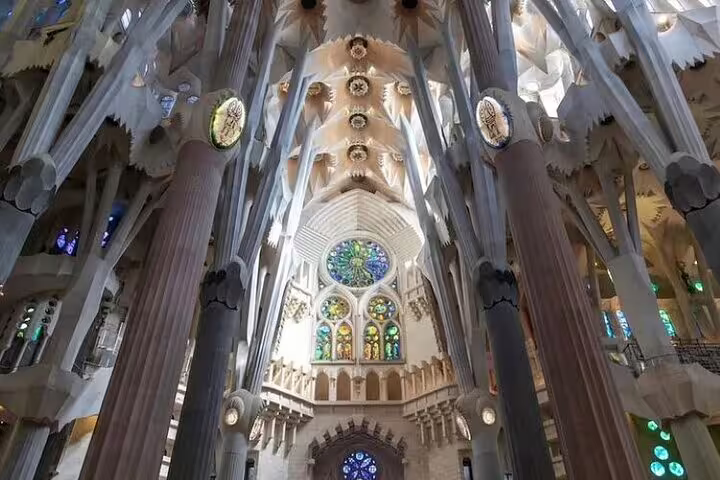 Interior of Sagrada Familia with soaring columns and stained glass, explored on an insider stories tour with fast-track entry