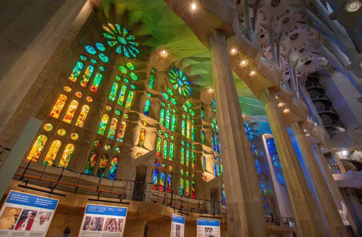 Vibrant stained glass windows inside Sagrada Familia, showcasing Gaudí's intricate design on a guided tour with skip-the-line access.