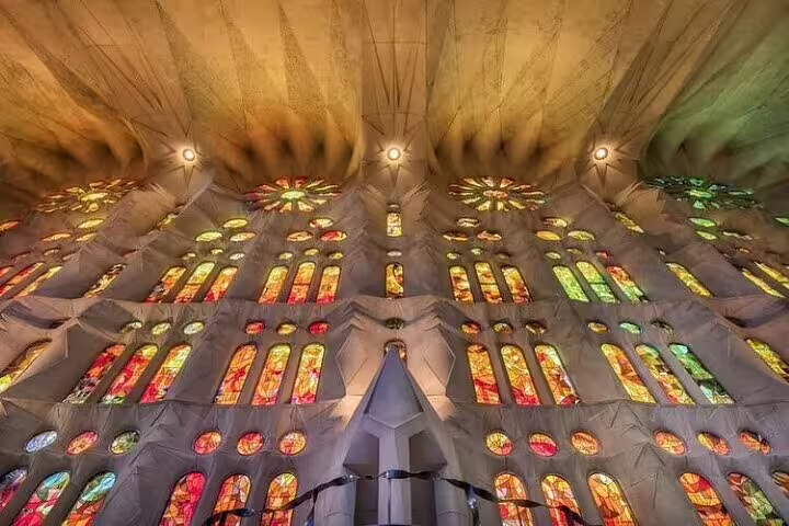 Close-up of Sagrada Familia’s glowing stained-glass windows and ceiling patterns seen on an insider stories tour in Barcelona