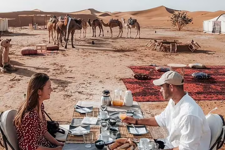 Luxury Sahara desert camp breakfast with camels, part of the 3 days desert tour from Fes to Marrakech