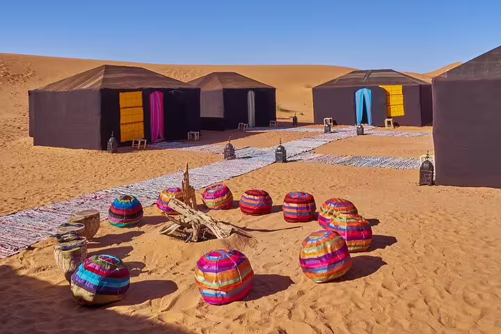 Sahara desert camp tents with colorful poufs in Erg Chebbi, Morocco 11-day tour from Casablanca