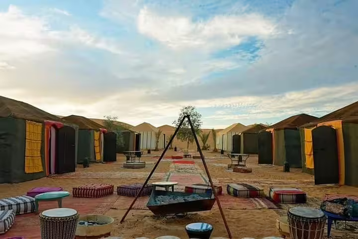 Sahara desert camp near Merzouga with Berber tents and fire pit, Morocco 8-day tour from Tangier