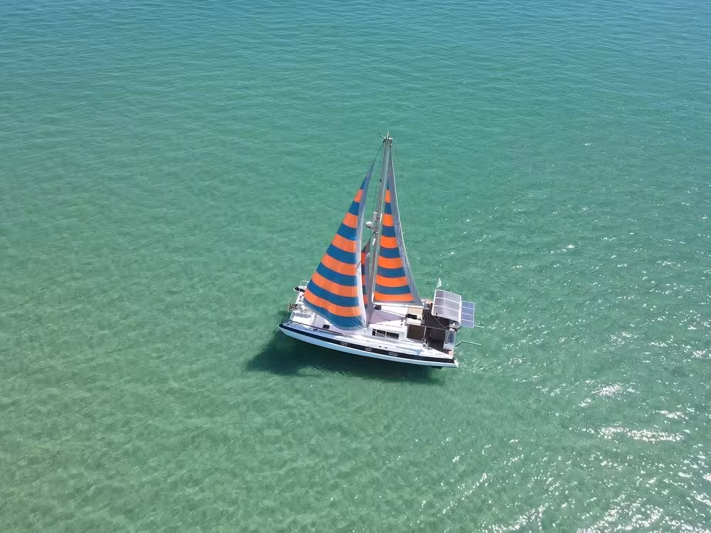 Aerial view of sail catamaran gliding over turquoise Blue Lagoon waters on a half-day sailing cruise